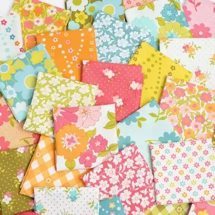 A vibrant assortment of colorful cotton patchwork fabric squares featuring vintage floral and gingham patterns for quilting.