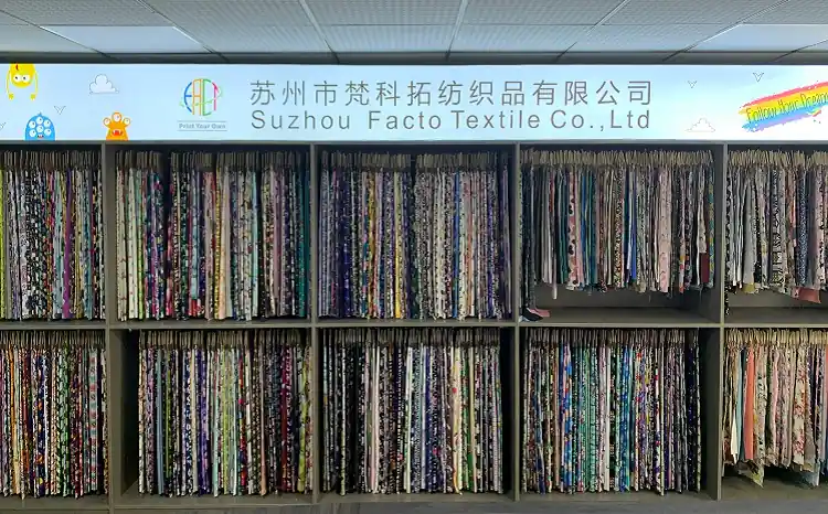 Wide variety of textile swatches and fabric samples displayed in the Facto Textile showroom.
