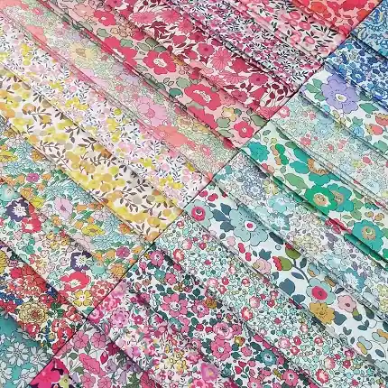A colorful assortment of liberty cotton floral quilting fabric with fine, detailed ditsy prints, perfect for fussy cutting.