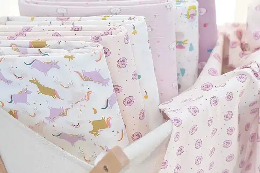 Colorful and cute printed cotton jersey fabrics for baby clothing, featuring unicorn, donut and animal patterns.
